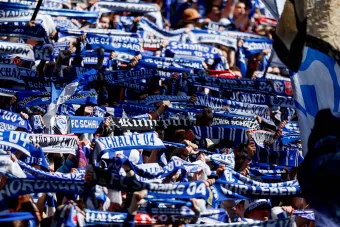 Fans in der Schalker Nordkurve die ihre Schalke Schals hochhalten